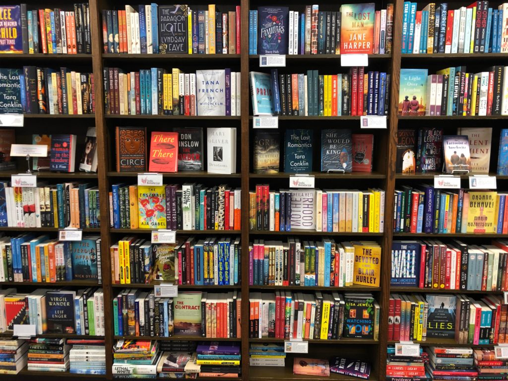 Bookcase showing different genres of novels